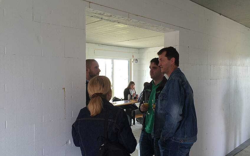Bernd Laatz mit Interessenten beim Rohbaufest im individuell geplanten Einfamilienhaus Futura Pult von Kern-Haus in Obrigheim