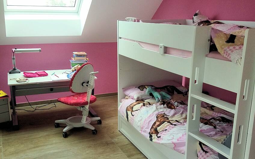 Kinderzimmer mit Bett und Schreibtisch