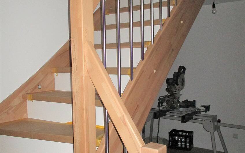 Treppengeländer mit Holzhandlauf und Edelstahl kombiniert.