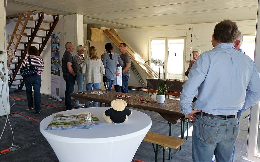 Gäste im Wohnzimmer bei der Rohbaubesichtigung der frei geplanten Kern-Haus-Stadtvilla in Jockgrim