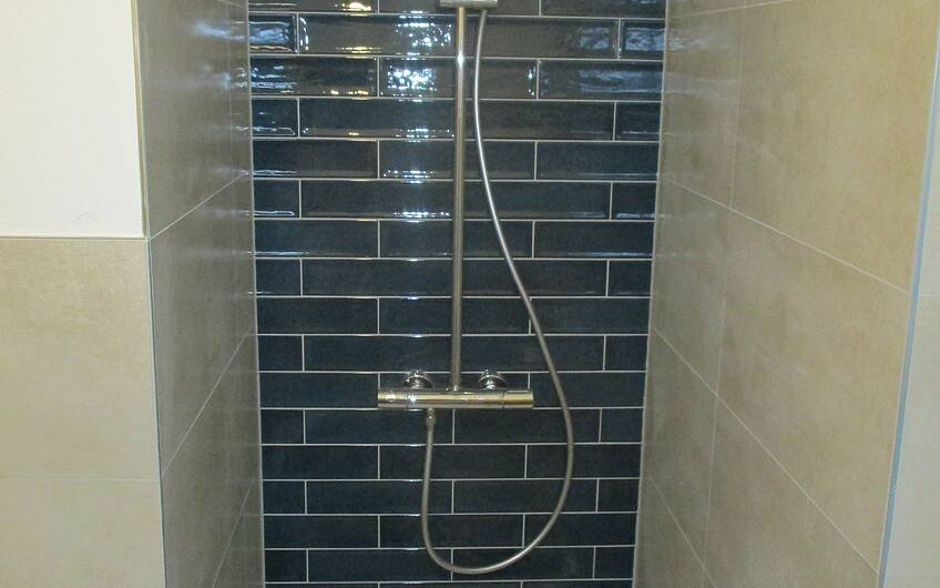 Im Gästeduschbad wurde die bodengleiche Duschtasse und Armatur befestigt.