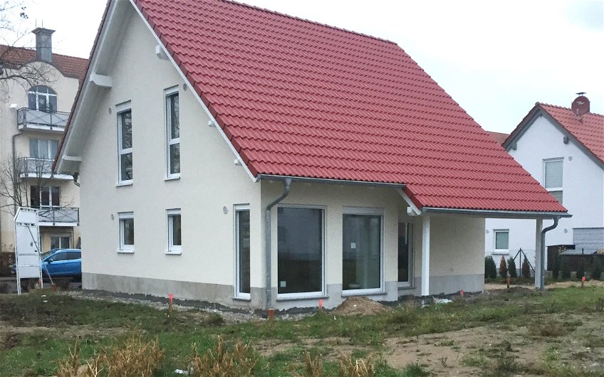 Dacheindeckung rote Ziegel auf Familienhaus mit Dachvorstand