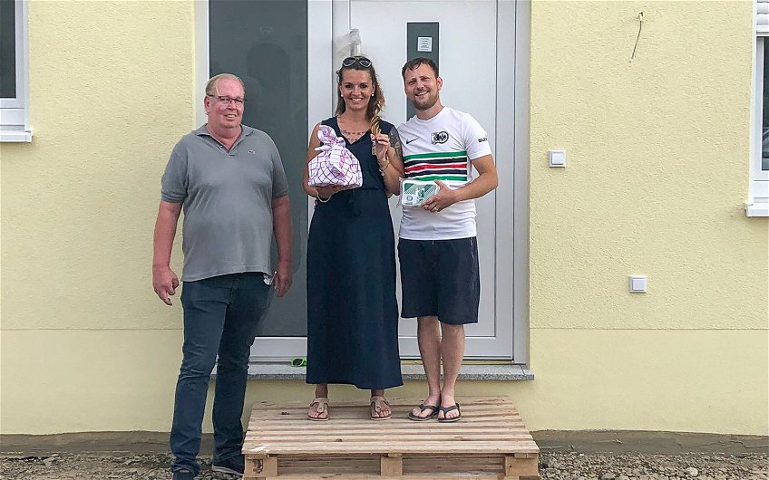 Hausübergabe mit Brot und Salz mit Bauherren und Kern-Haus Bauleiter vor Haustür der Kern-Haus Stadtvilla in Pegau