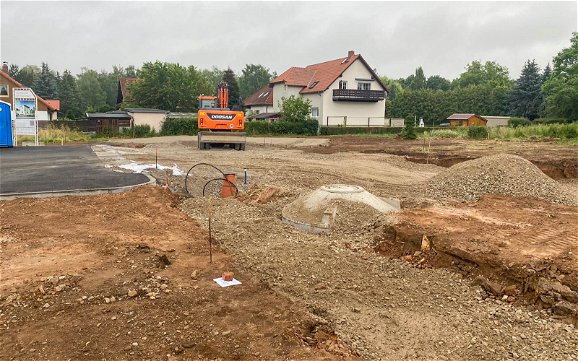 Tiefbauarbeiten mit Bagger auf Grundstück vor Baubeginn des Kern-Haus in Regis-breitingen