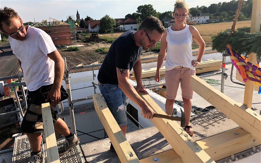 Bauherren auf dem Dach ihres Kern-Haus Bungalows Trio in Magdeburg