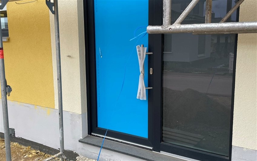 Die Haustür wurde passend zur Farbe der Fenster gewählt.