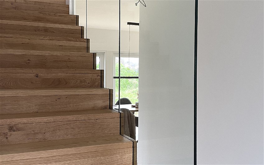 Die raumhohe, repräsentative Verglasung im Treppenhaus hat eine absturzsichernde Funktion und verleiht diesem eine größere Raumwirkung.